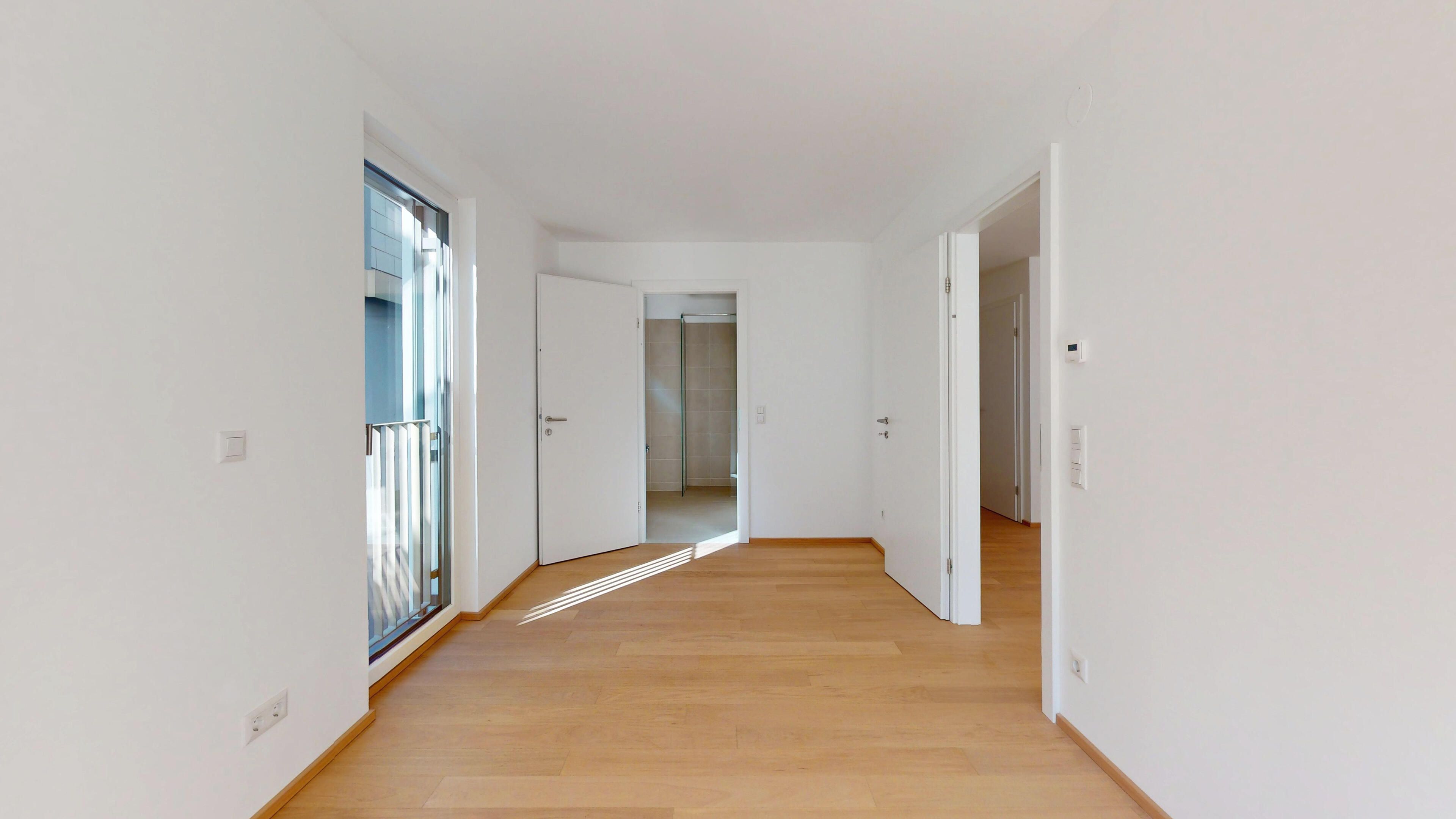 Darstellung eines Schlafzimmers mit Blick in Richtung Badezimmer